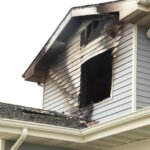 A house with a rooftop fire poses a significant risk of fire damage.