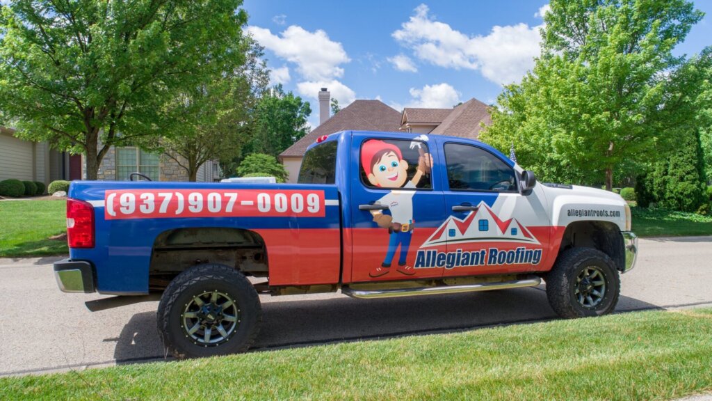 A truck is parked in front of a house, potentially for hiring a roofing contractor.