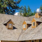 A house with a shingled roof and ventilation.