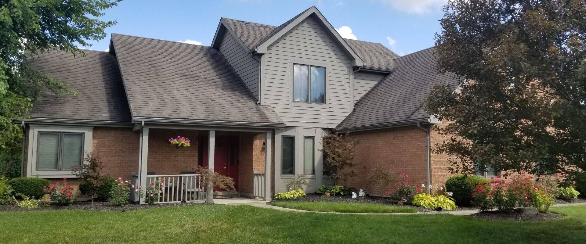 A home with a lot of grass in front of it located in Dayton.