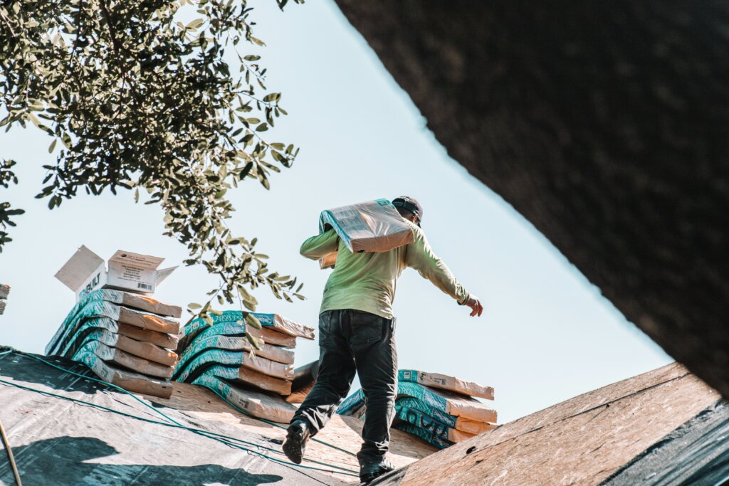 roofing contractor walking on a roof ready for repair