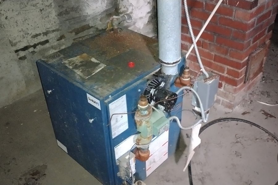 Aging oil boiler in basement of pre-1960 Buffalo NY home — major contributor to high heating costs in WNY older housing stock