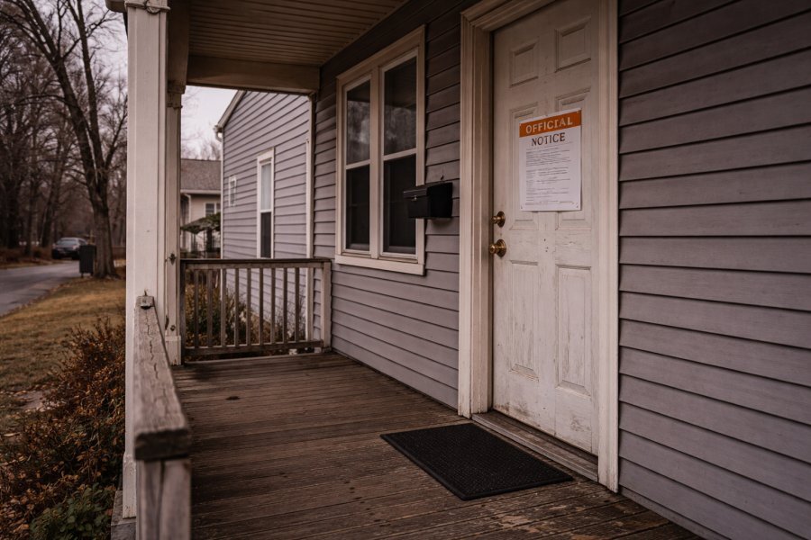 Worn rental property in Cheektowaga NY with official notice on door — mid-eviction Buffalo area property NCB purchases as-is without requiring completion of proceedings