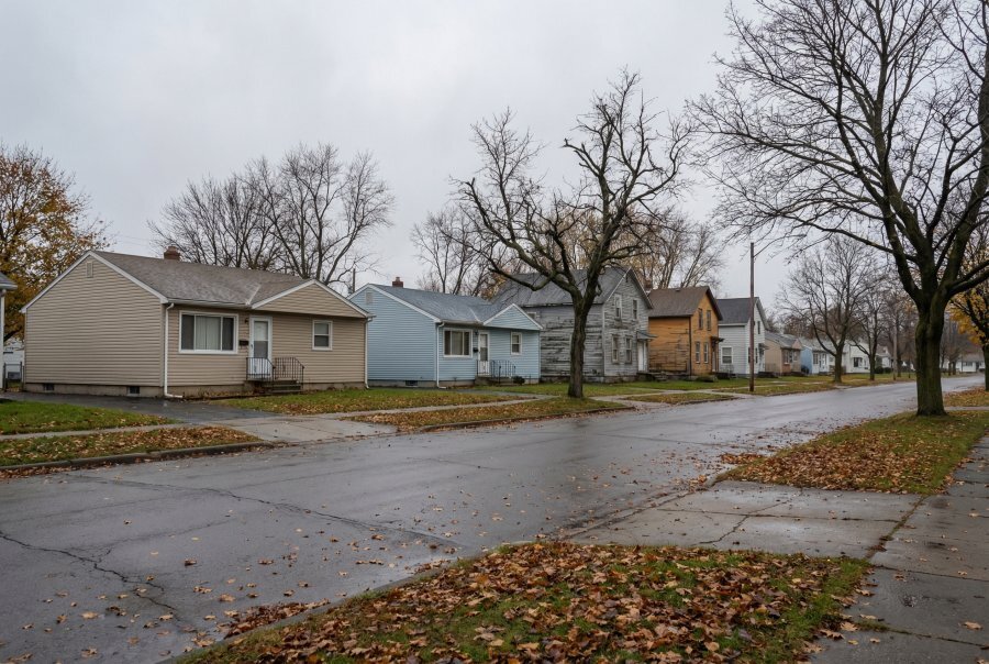 Quiet residential street in Cheektowaga NY in late autumn — typical Erie County suburb where property tax liens affect homeowners