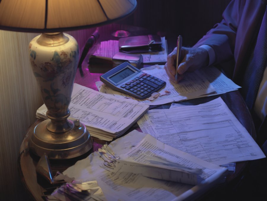 Erie County property tax bill next to rental income ledger — high taxes compressing returns for Buffalo NY landlords