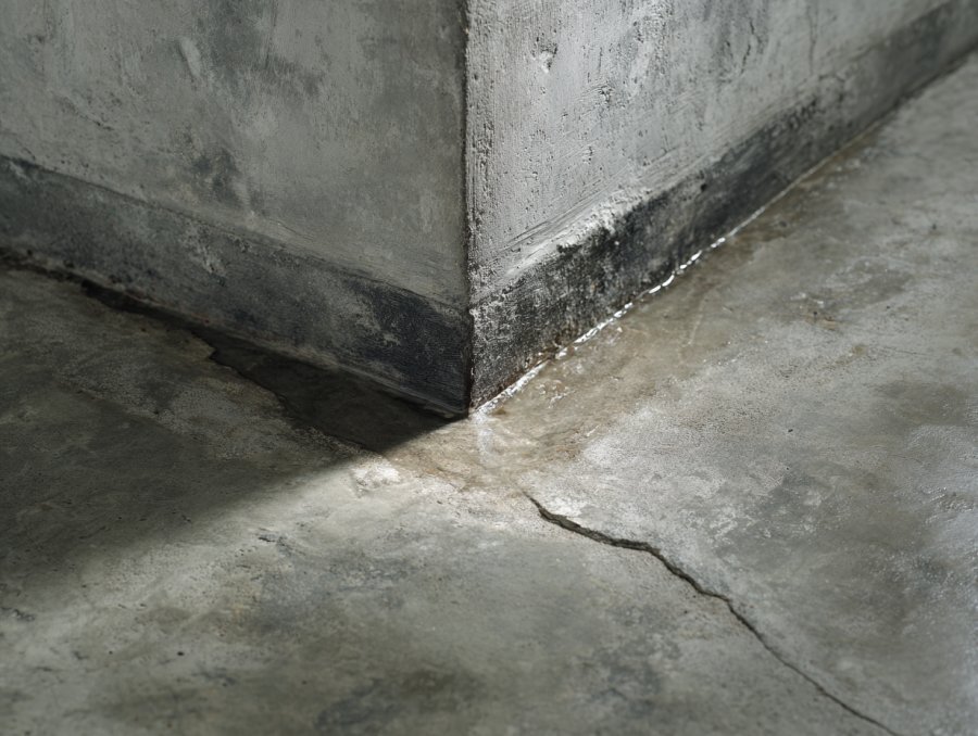 Poured concrete basement wall crack with water staining — freeze-thaw damage in Buffalo NY home