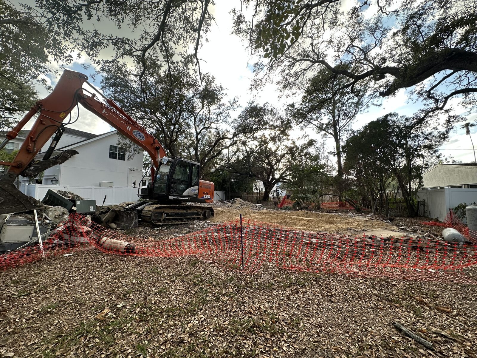 Excavator clearing a South Tampa teardown