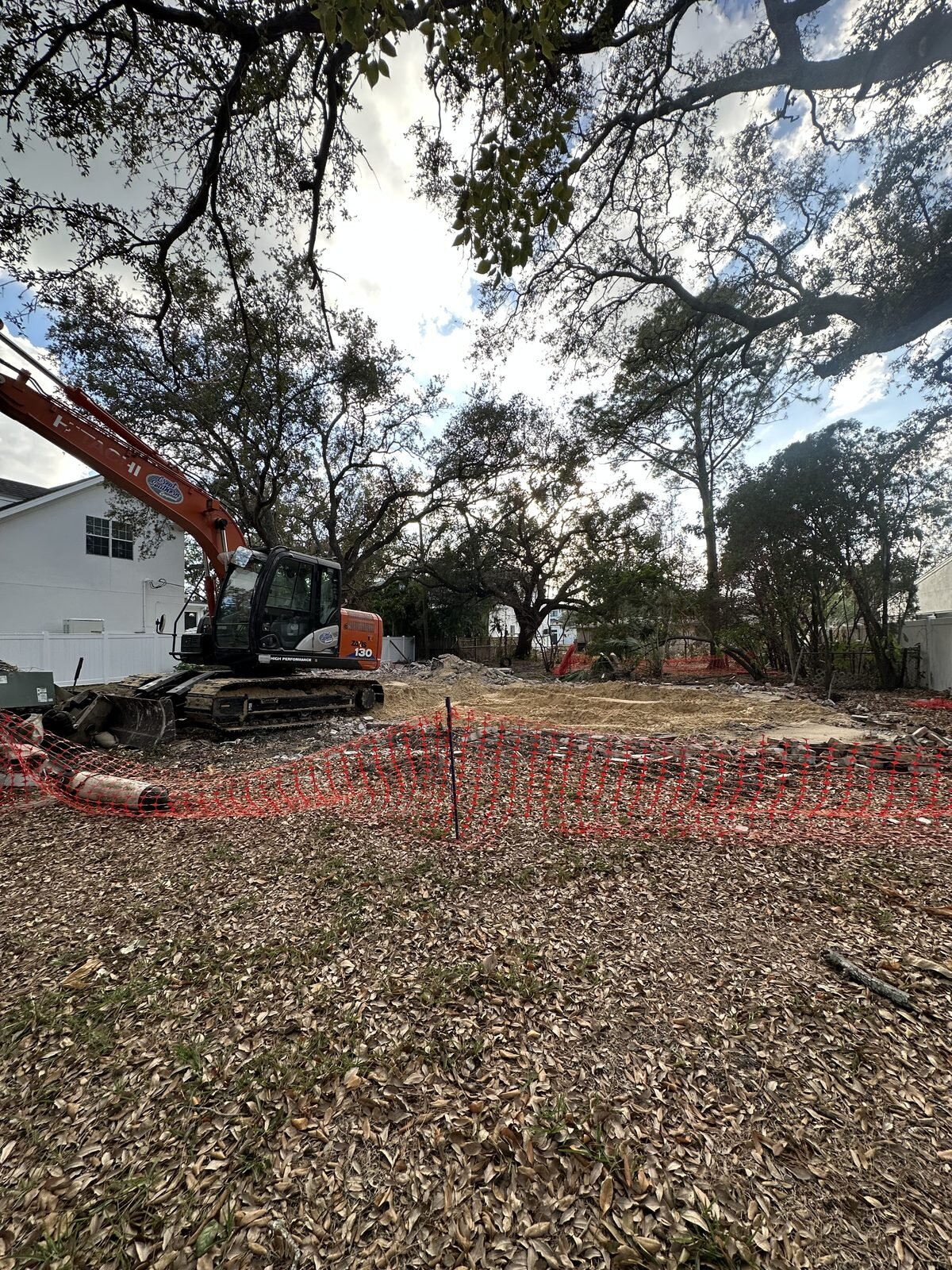 Excavator and debris on a South Tampa lot as an older house is cleared