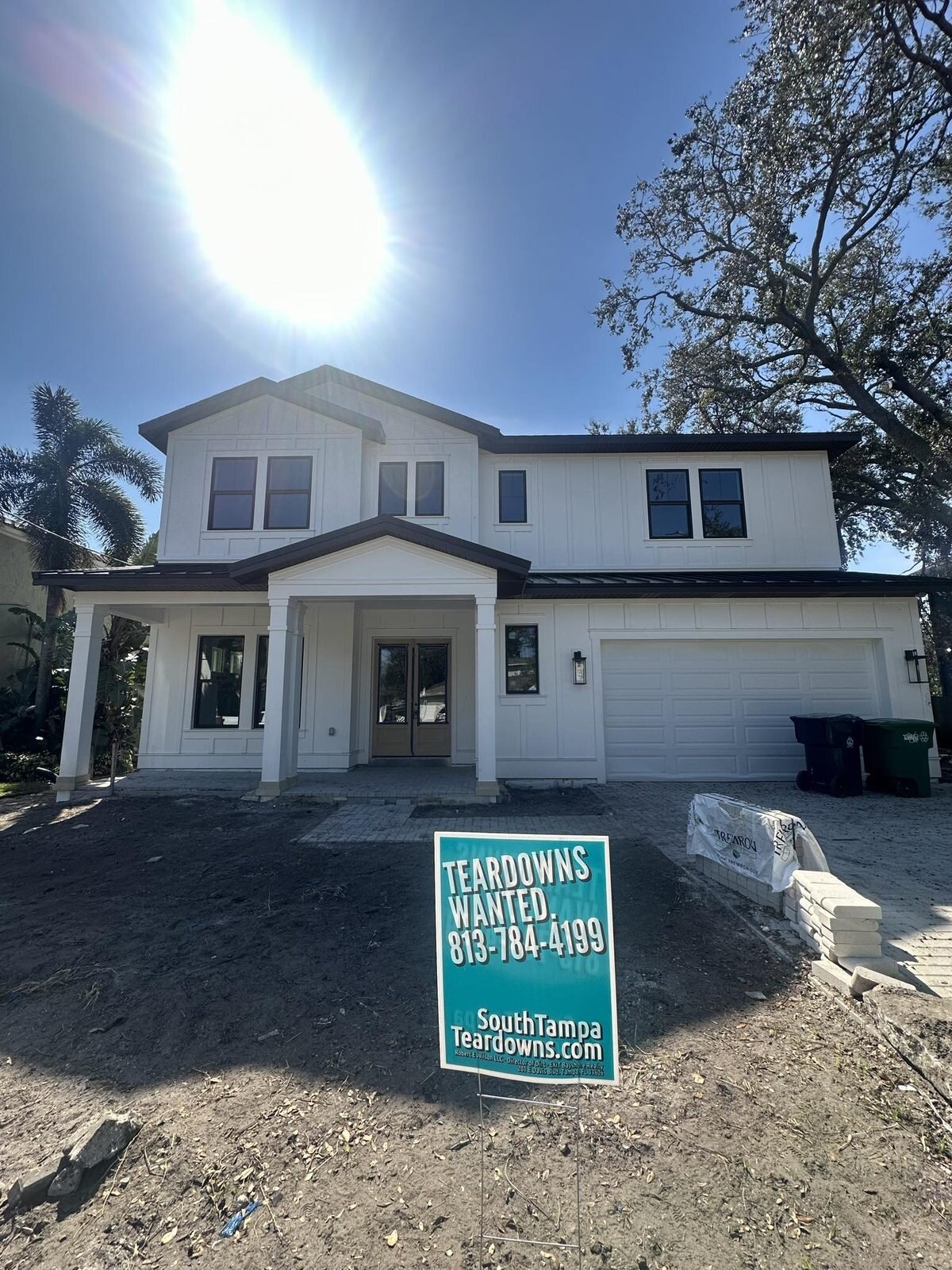 Newly built two-story South Tampa house with a Teardowns Wanted sign in the yard