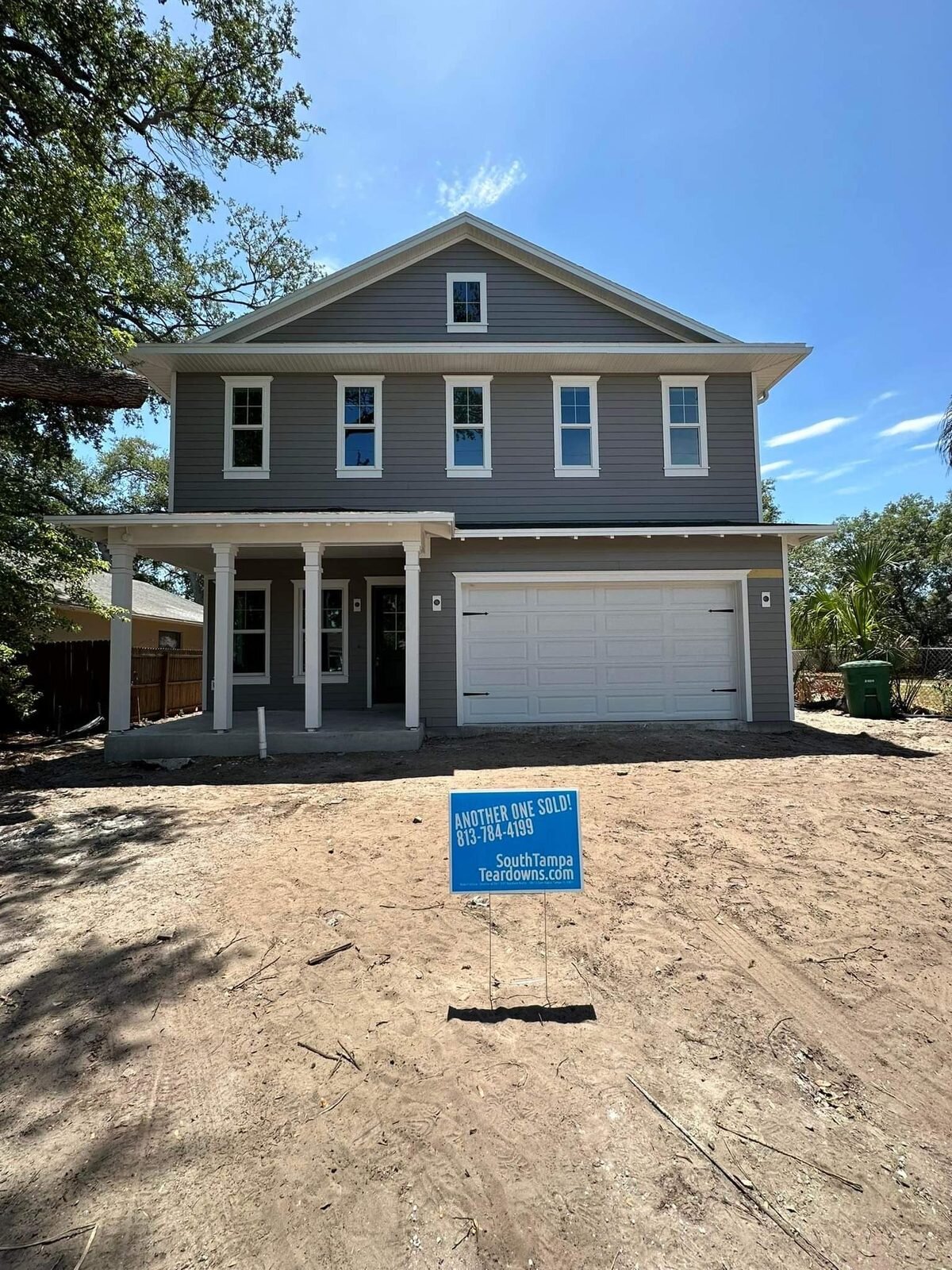 Newly built two-story South Tampa house with an Another One Sold sign in the front yard
