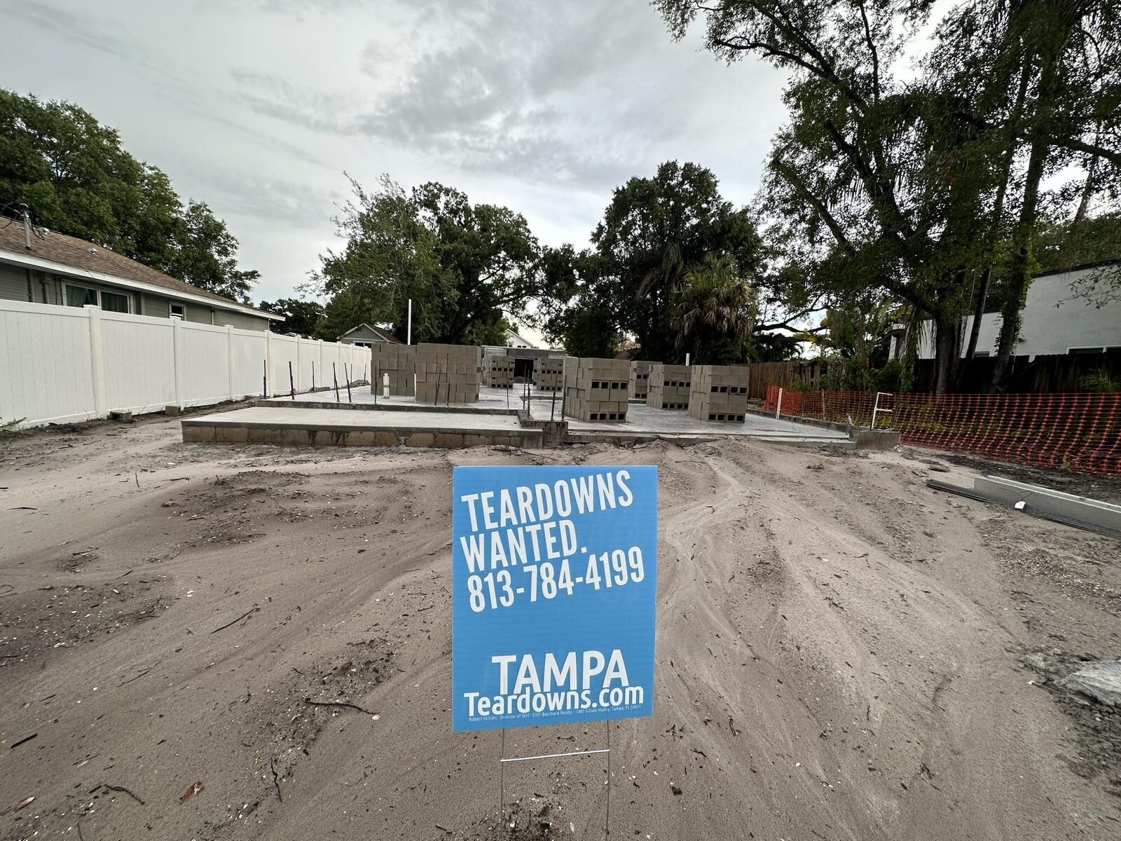 Concrete slab and block pallets on a cleared Tampa lot with a Teardowns Wanted sign from TampaTeardowns.com