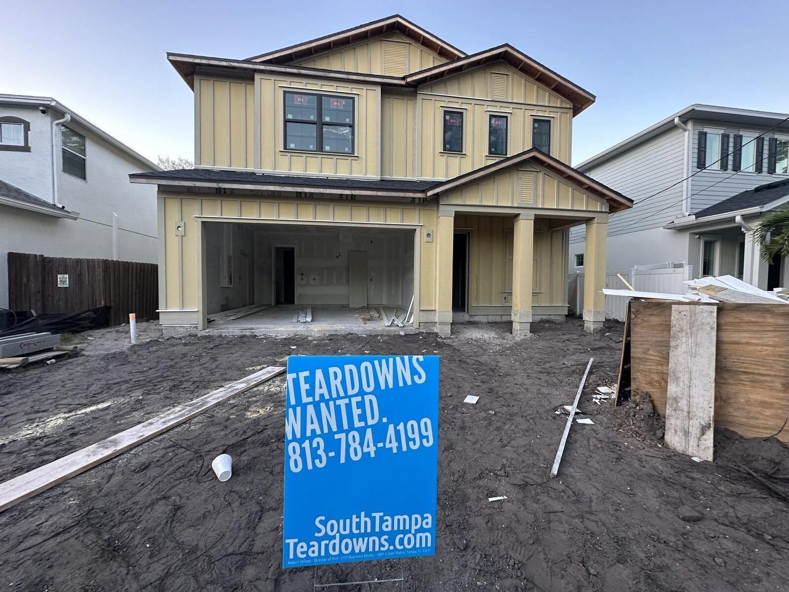 New two-story house nearing completion on a Tampa lot with a Teardowns Wanted sign