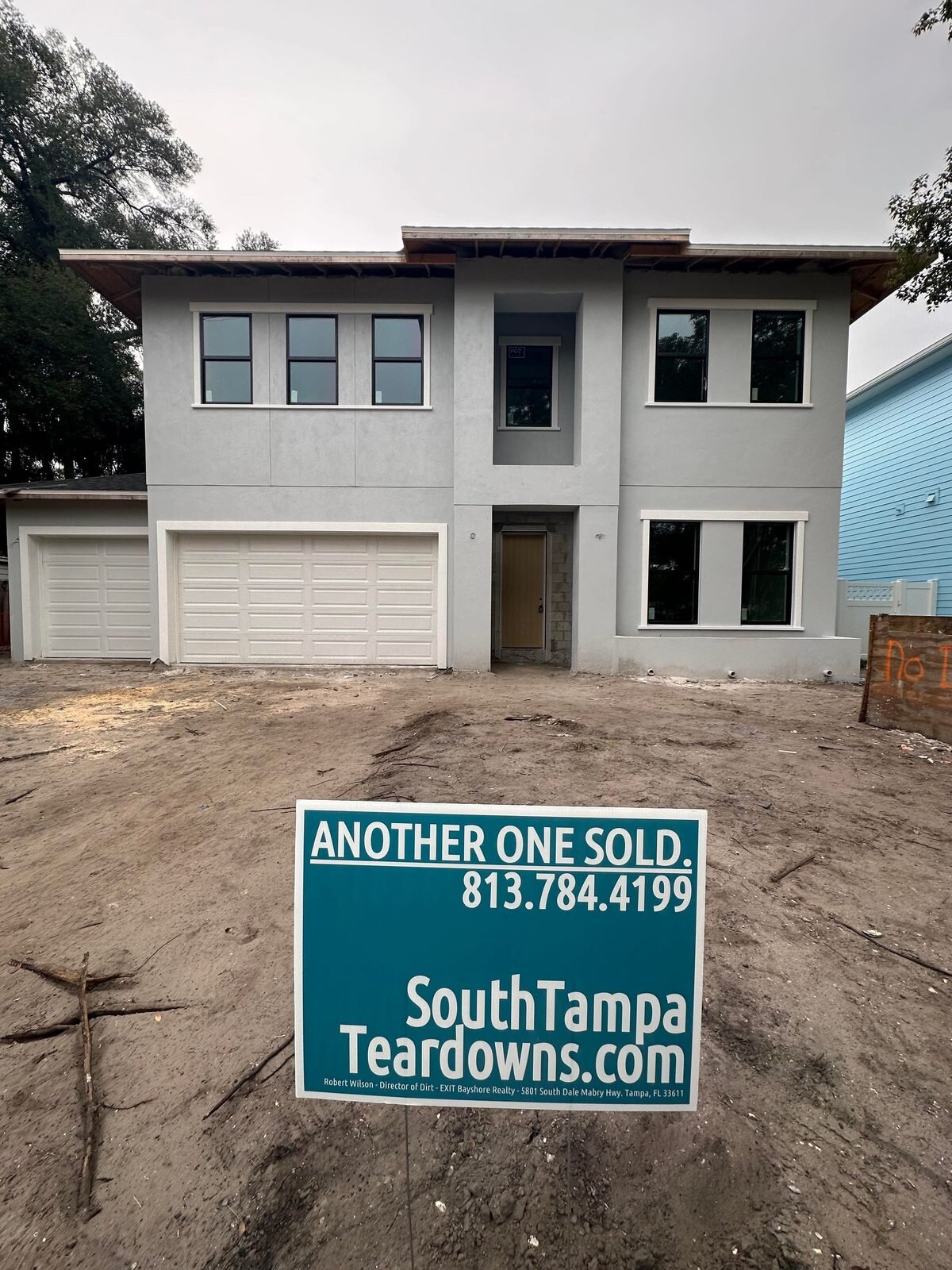 New two-story Tampa house with an Another One Sold sign in the front yard