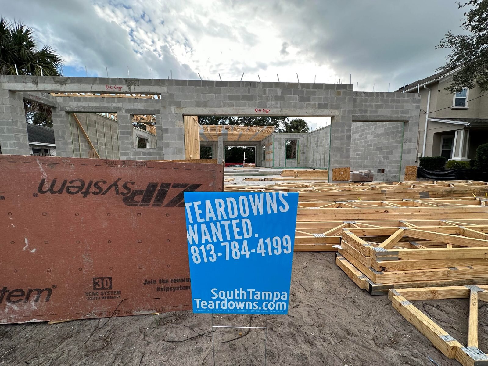 New home framing on a South Tampa lot, with a Teardowns Wanted sign
