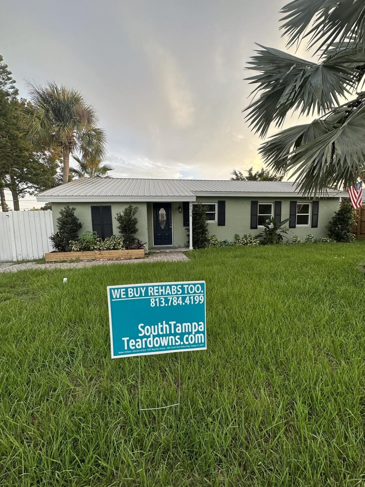 South Tampa house with a We Buy Rehabs Too sign in the yard