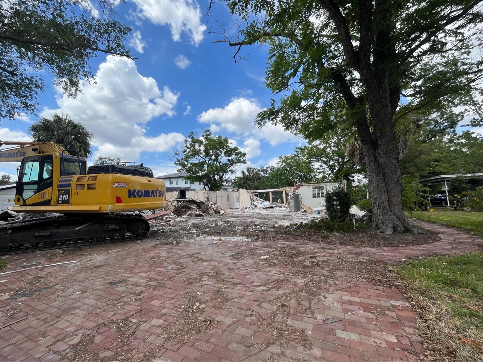 Excavator taking down an older South Tampa house