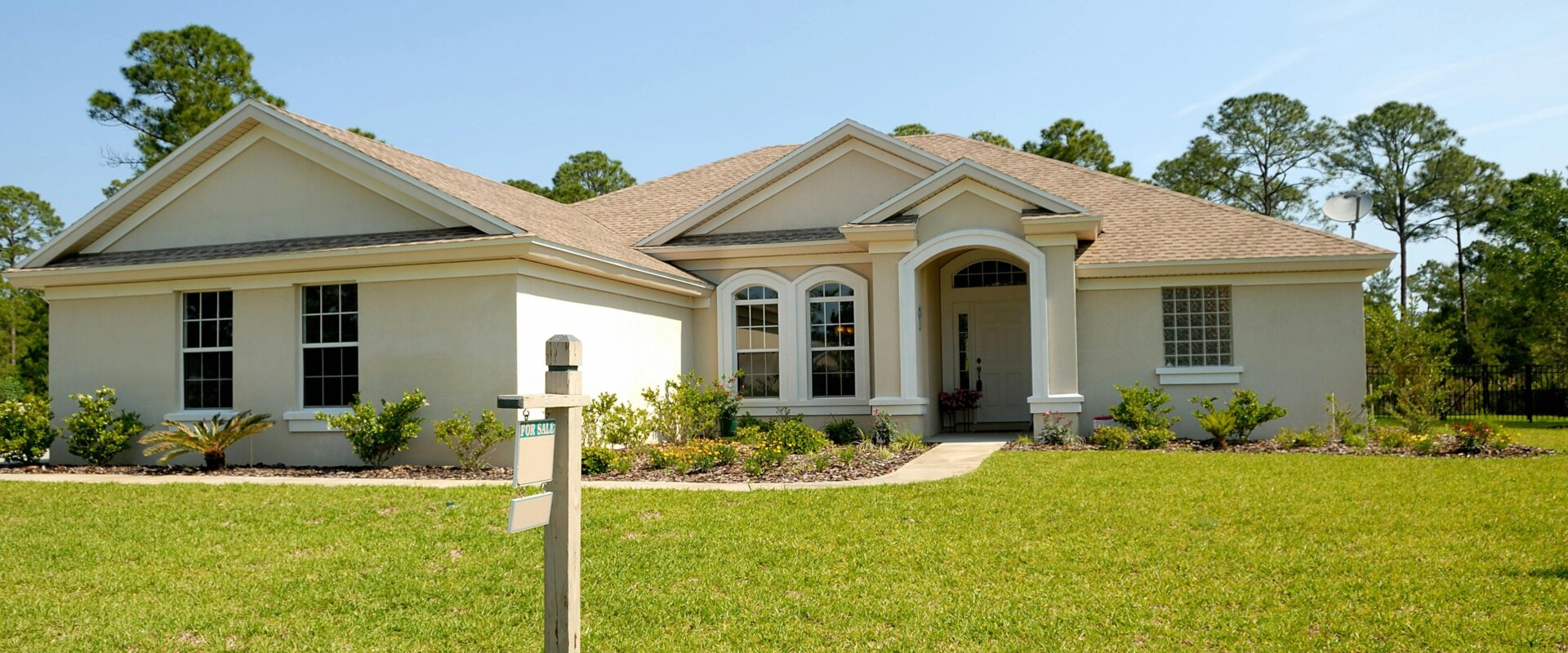 white and brown concrete bungalow under clear blue sky