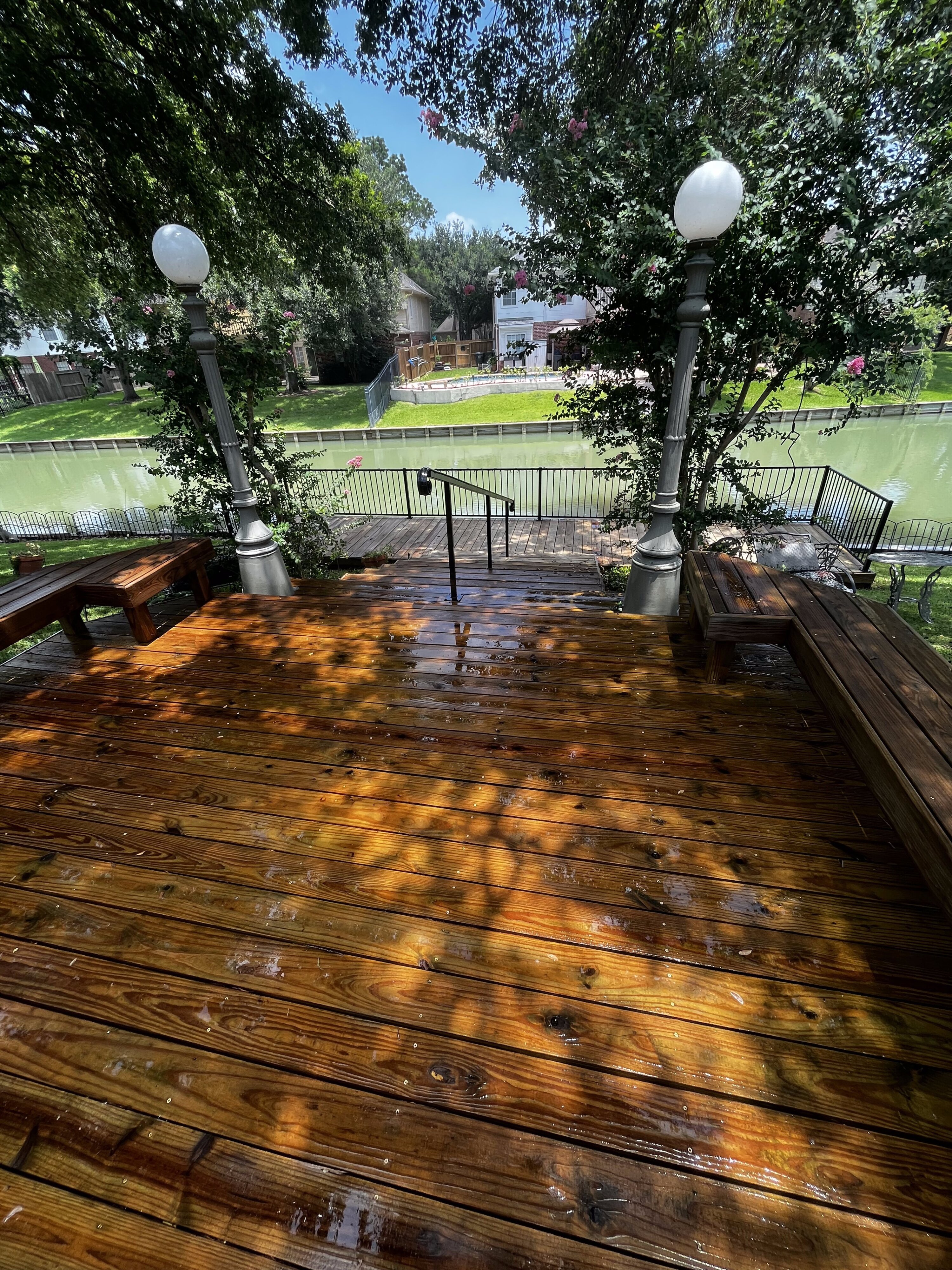 Restored wood deck by the water after cleaning in The Woodlands, TX