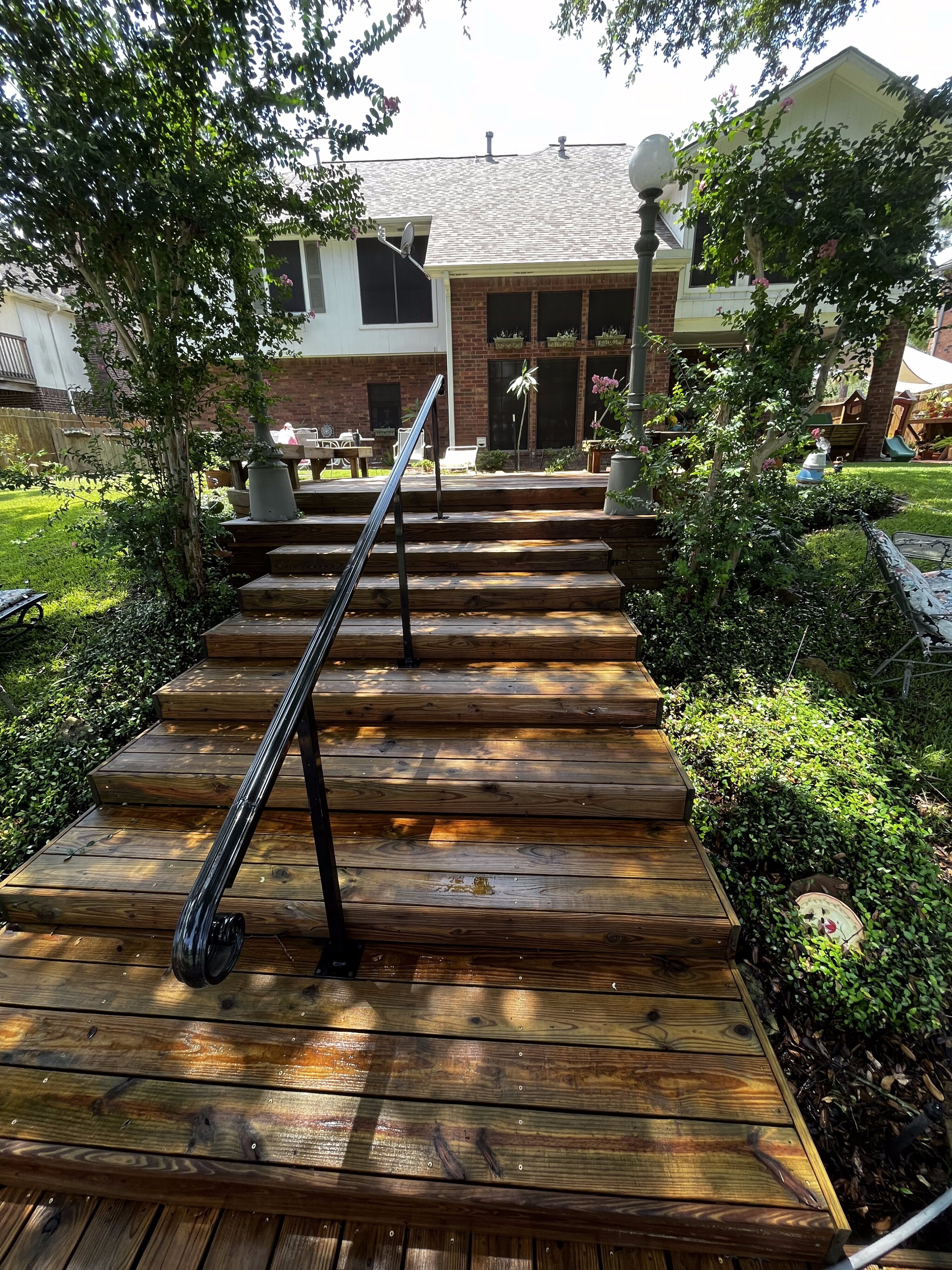 Wood stairs and handrail after washing and restoration in The Woodlands, TX