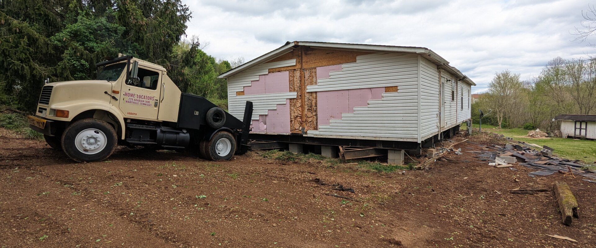 mobile home moving truck hooked up to double wide manufactured home