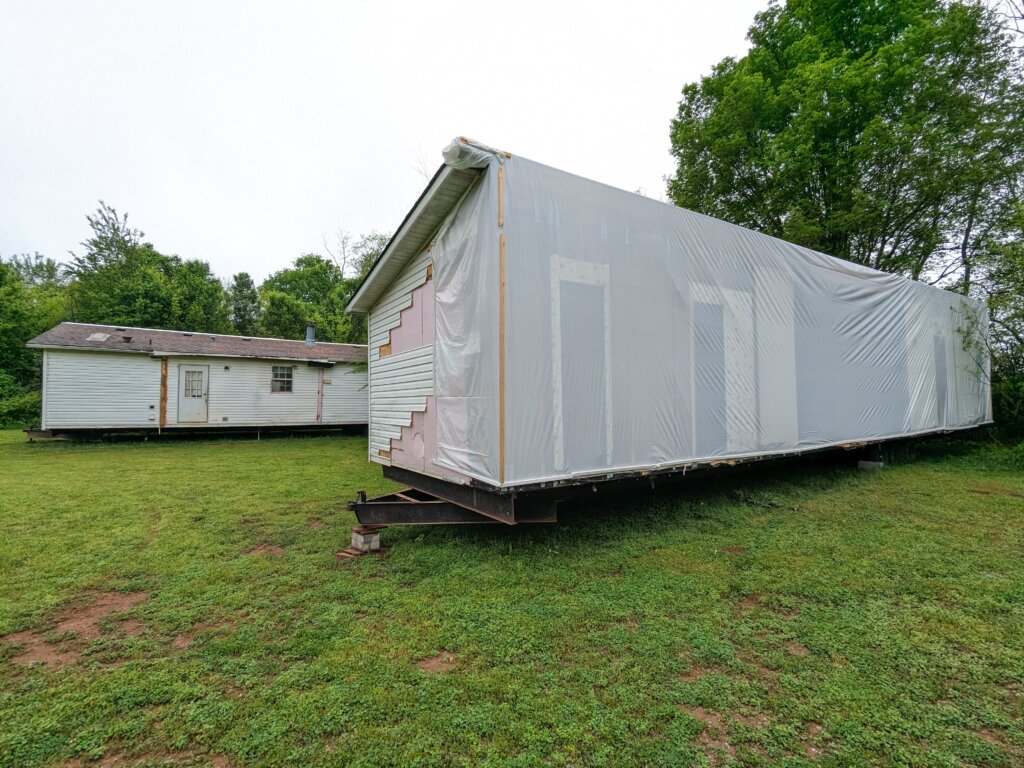 white doublewide wrapped in plastic for transportation
