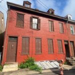 Pittsburgh red row house purchased by We Buy Property cash home buyers