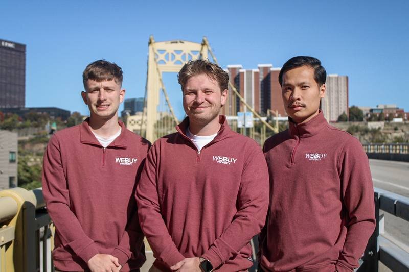 The We Buy Property team on a Pittsburgh bridge