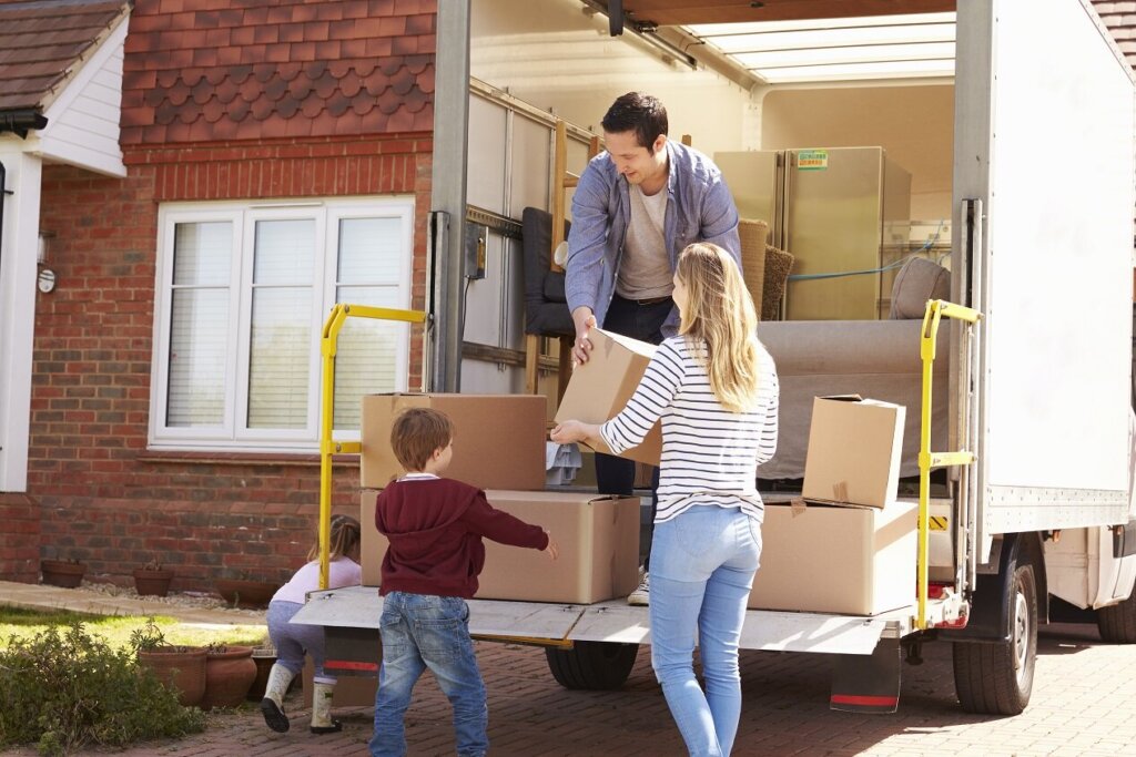 Homeowner packing moving boxes outside a house in McAllen, Texas, before relocating