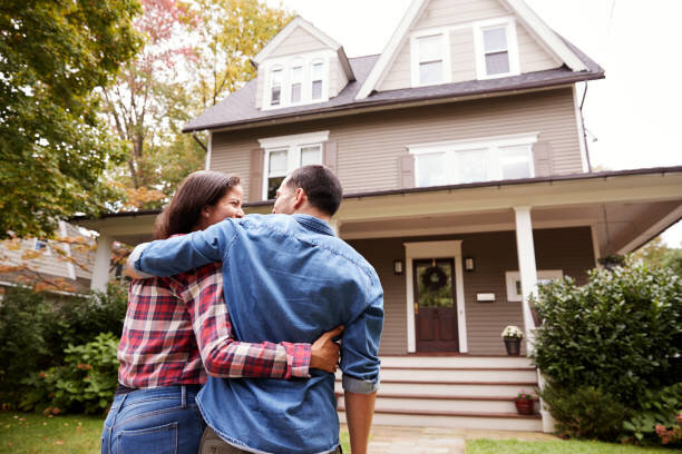 Happy couple outside their house