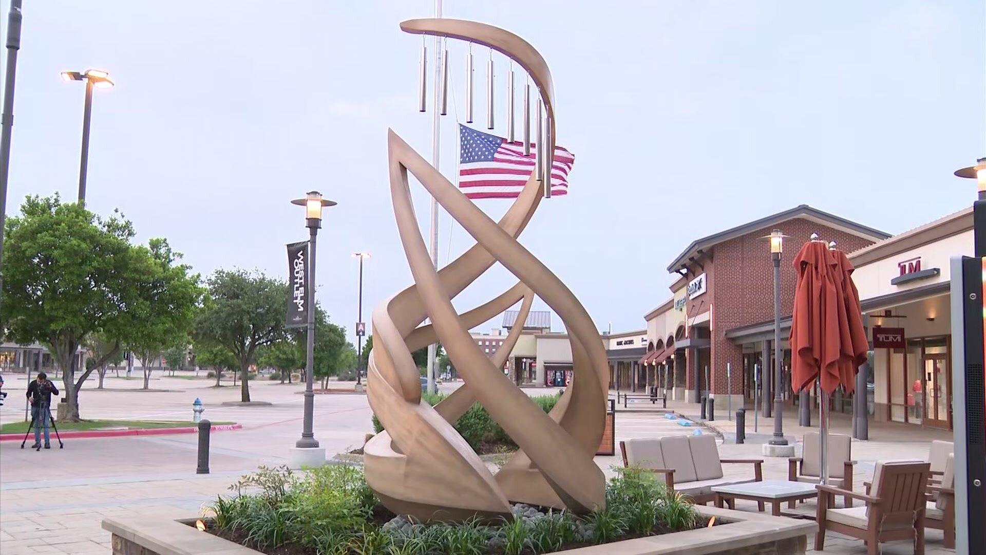 Allen Premium Outlets sculpture and American flag in Allen TX