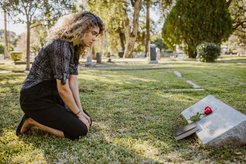 Adult in Georgia looking at headstone of a family member that left a house to them.