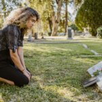 Adult in Georgia looking at headstone of a family member that left a house to them.