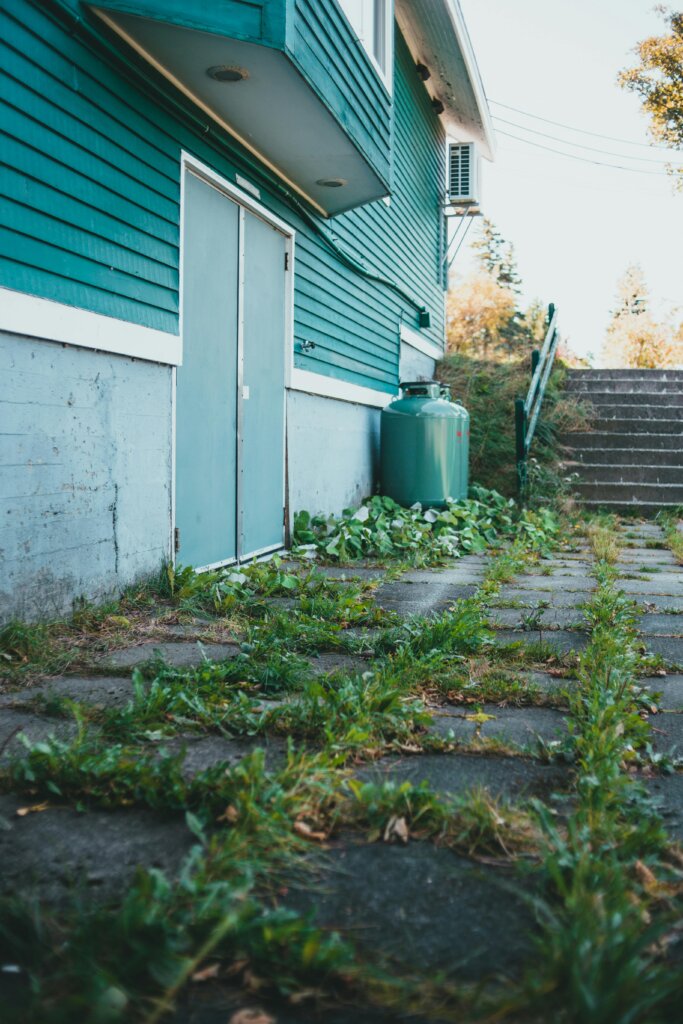 Vacant inherited home with overgrown yard and unpaid bills