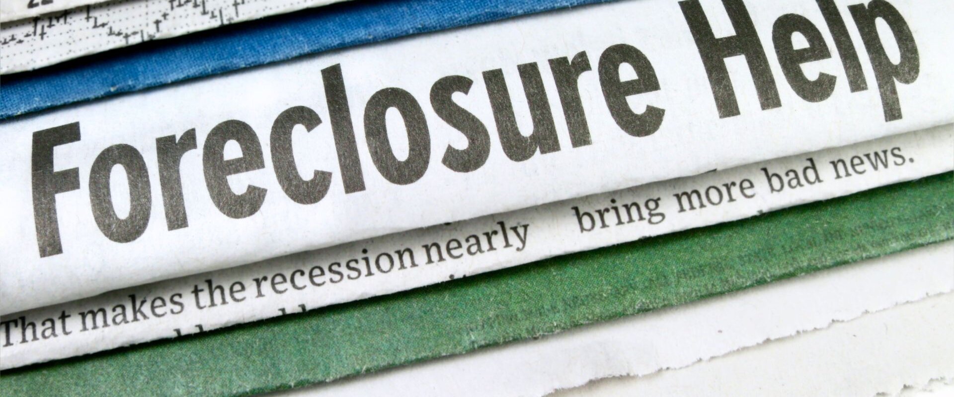 Newspaper with a headline saying "Foreclosure Help"