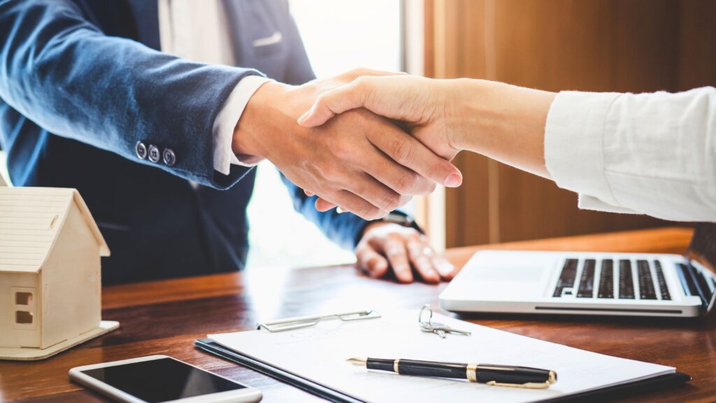 Handshake between buyer and seller in Rome, GA.