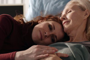 daughter caring for mother on bed
