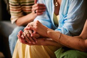 daughters of naomi women sitting caring for each other