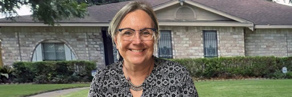Becky from Grandma House Buyer standing in front of a Houston home helping homeowners understand their selling options