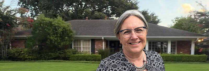 Becky Fields the Grandma House Buyer in front of a southwest Houston brick house