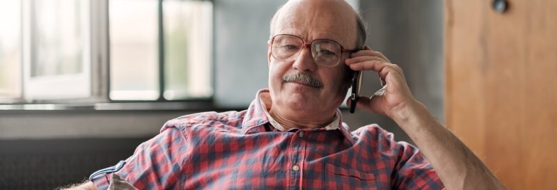 An older man on the phone, working through questions about an inherited property and next steps