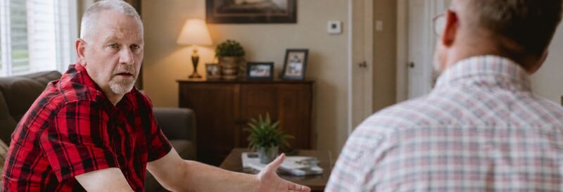 Two family members in a difficult conversation about what to do with an inherited property