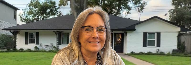 Becky Fields standing outside a one-story ranch rental property in Southwest Houston