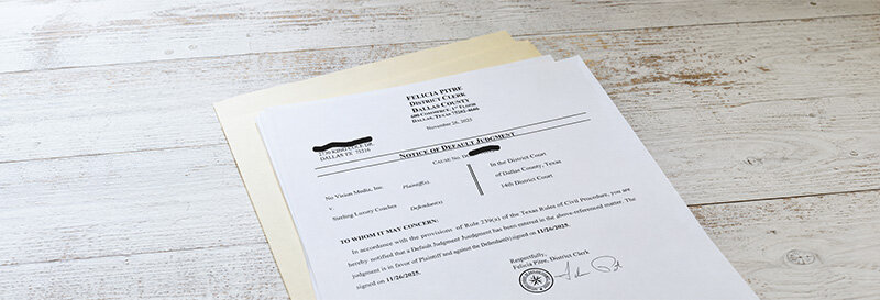 Close-up of an official Notice of Default letter on a kitchen table