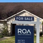 For Sale sign in front of a southwest Houston ranch style home