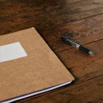 a notarized set of legal documents in a folder resting on a desk