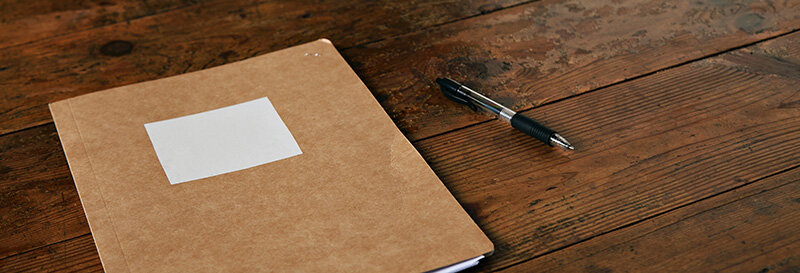 notarized legal document in a folder resting on a desk