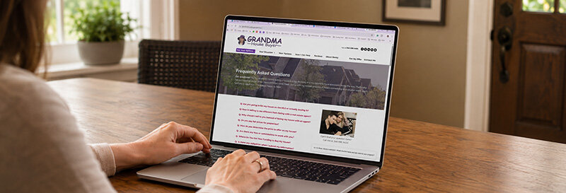 Woman researching her options facing foreclosure on a laptop at a home kitchen table
