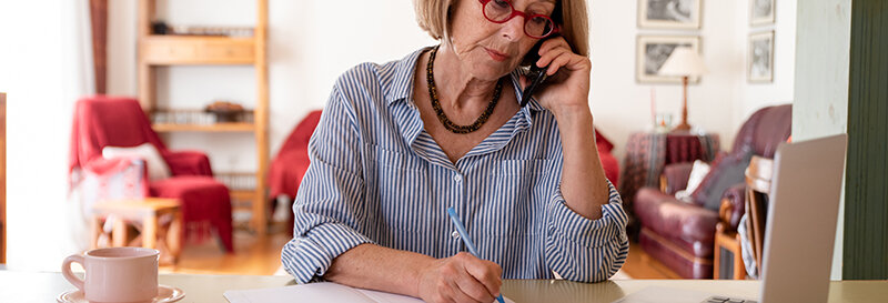 Middle age senior woman working at home using computer in Houston