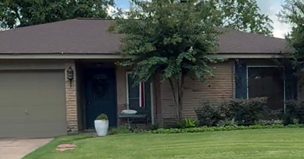 Brown Brick Suburban Ranch House in Bellaire TX with landscaping and a mowed front yard