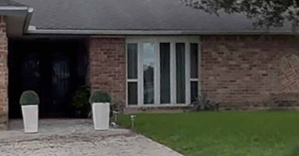 Red Brick Suburban Ranch House in La Porte TX with gateway planters on porch and a front bay window near the entrance